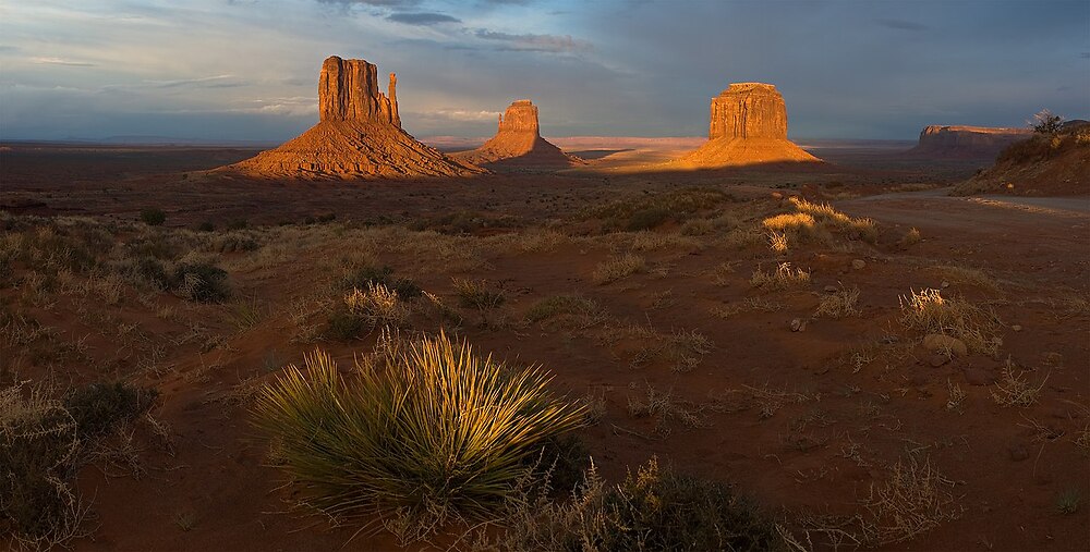 The Monument Valley Navajo Tribal Park at sunset. From left to right: Sentinel Mesa, The Mittens, and Merrick Butte