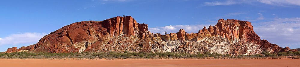 The Rainbow Valley Conservation Reserve, located about 75km south of Alice Springs in the Northern Territory of Australia, is known for its spectacular red sandstone bluffs. Panaroma shot of eight portrait format pictures, taken in the late afternoon