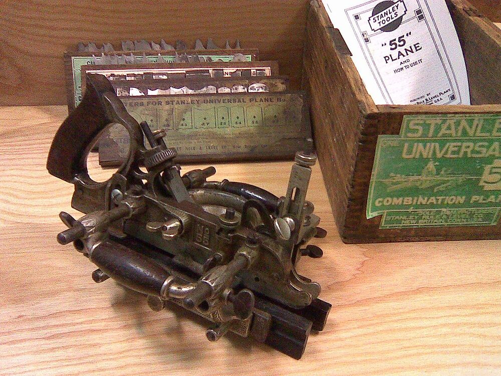 A Stanley 55 “Universal Combination Plane”, allowing the combination of a wide variety of cutters (shown in the background), to perform various woodworking tasks, such as molding